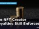Two stacks of gold coins, one tall and one short, under dramatic side lighting representing paid versus unpaid NFT creator royalties